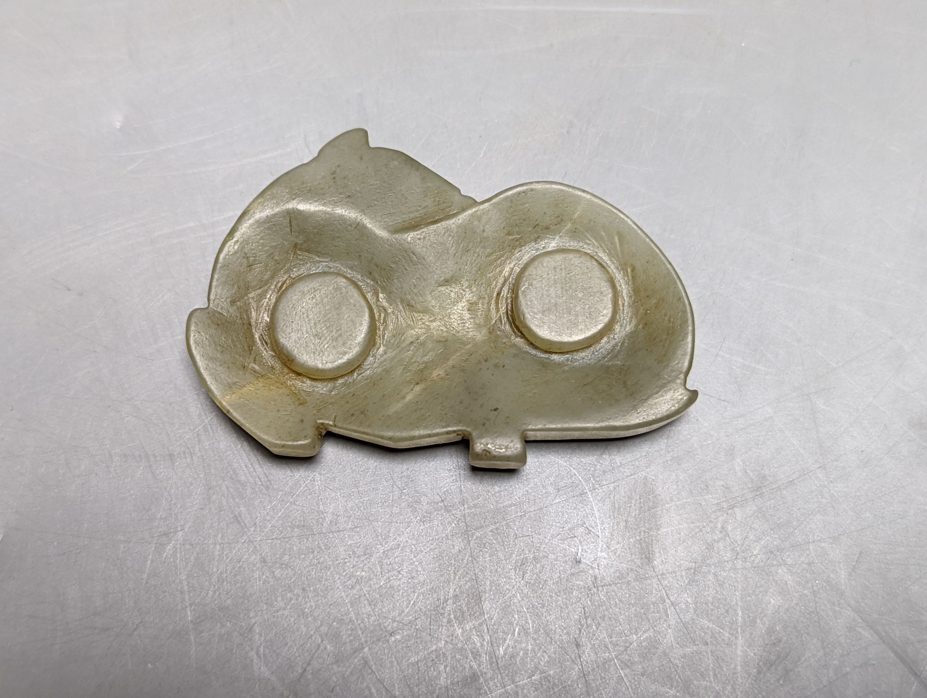 A Chinese jade carving of a resting horse, 7cm and a Himalayan cast gilt-bronze mount